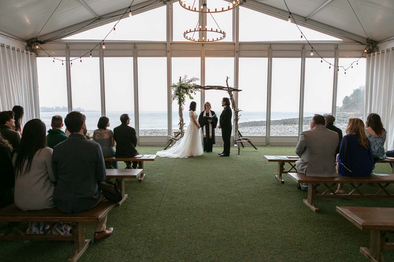 Megan and Andrew with the officiant and both families during the ceremony