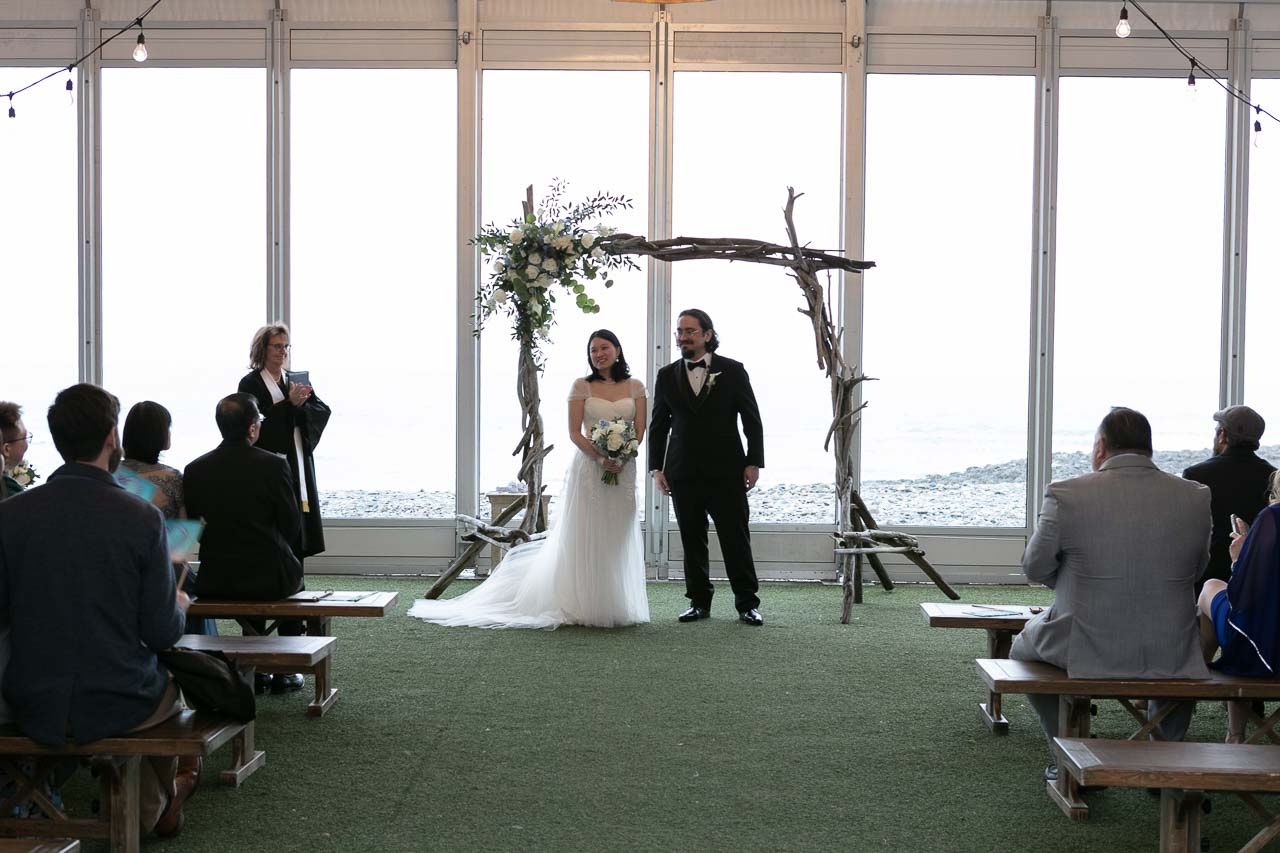 Megan and Andrew with the officiant during the wedding ceremony walking back down the aisle as a married couple