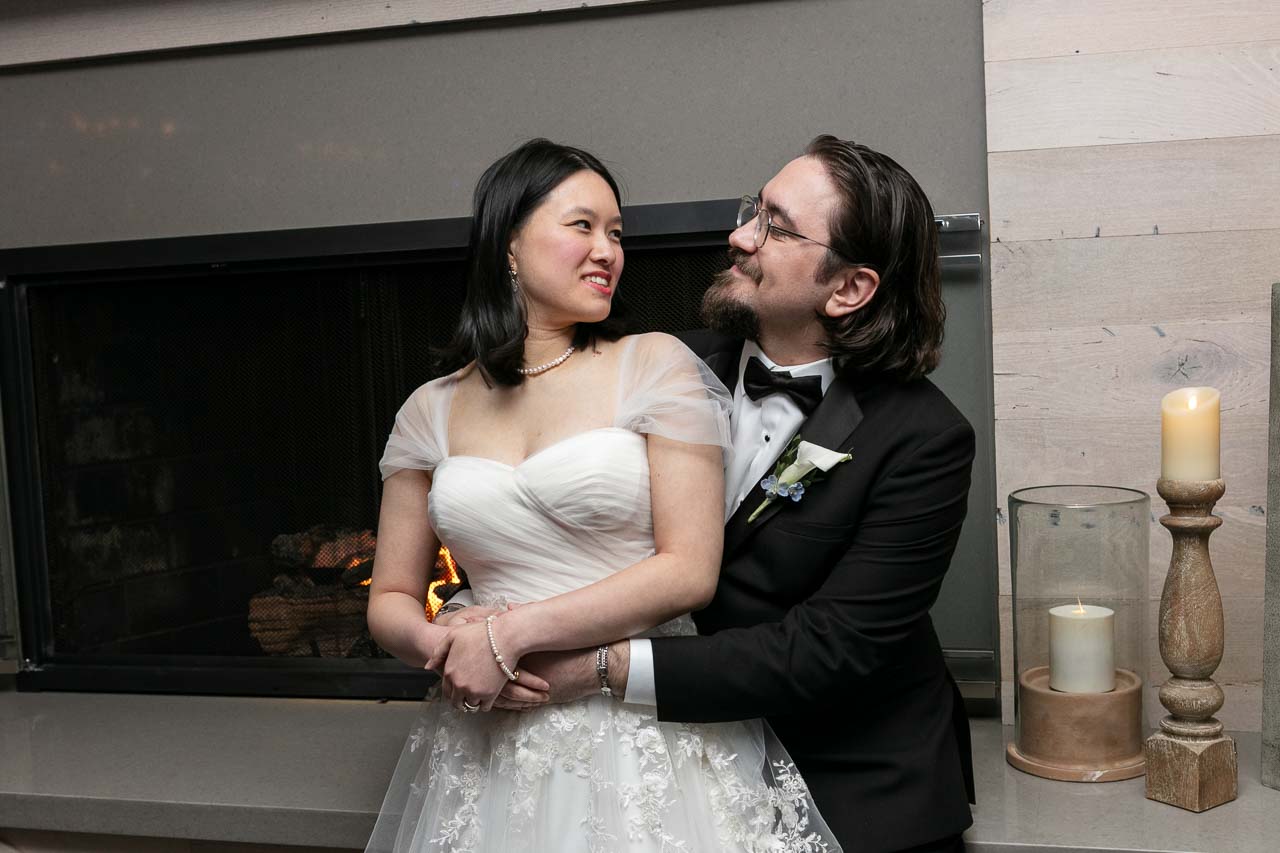 Megan and Andrew hugging in front of the fireplace