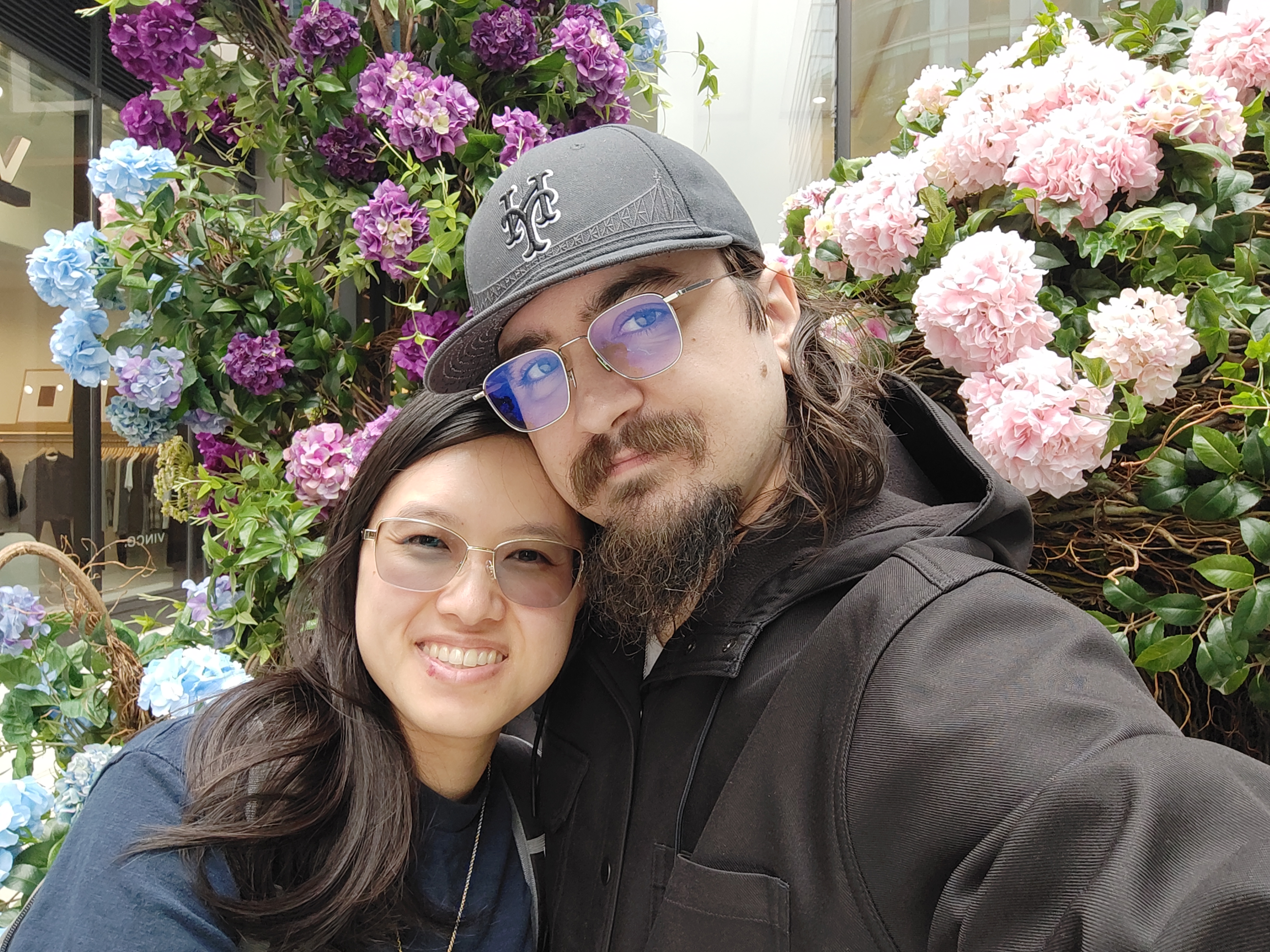 Megan and Andrew in the Boston Seaport, in front of beautiful flowers.